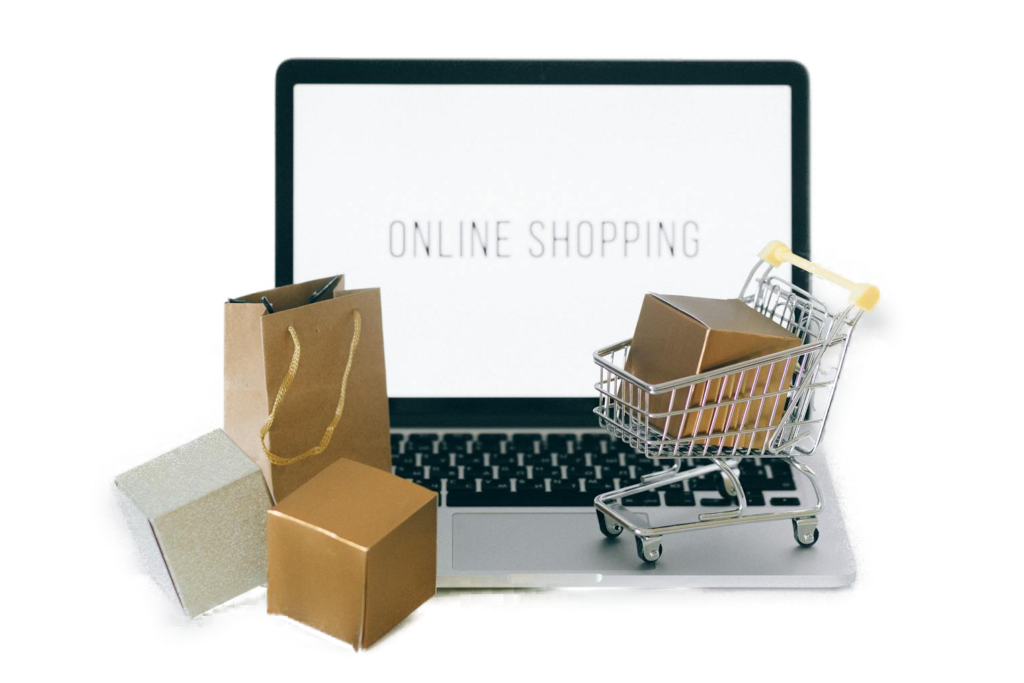 Ordenador con el texto "ONLINE SHOPPING", y cajas y un carrito en miniatura delante